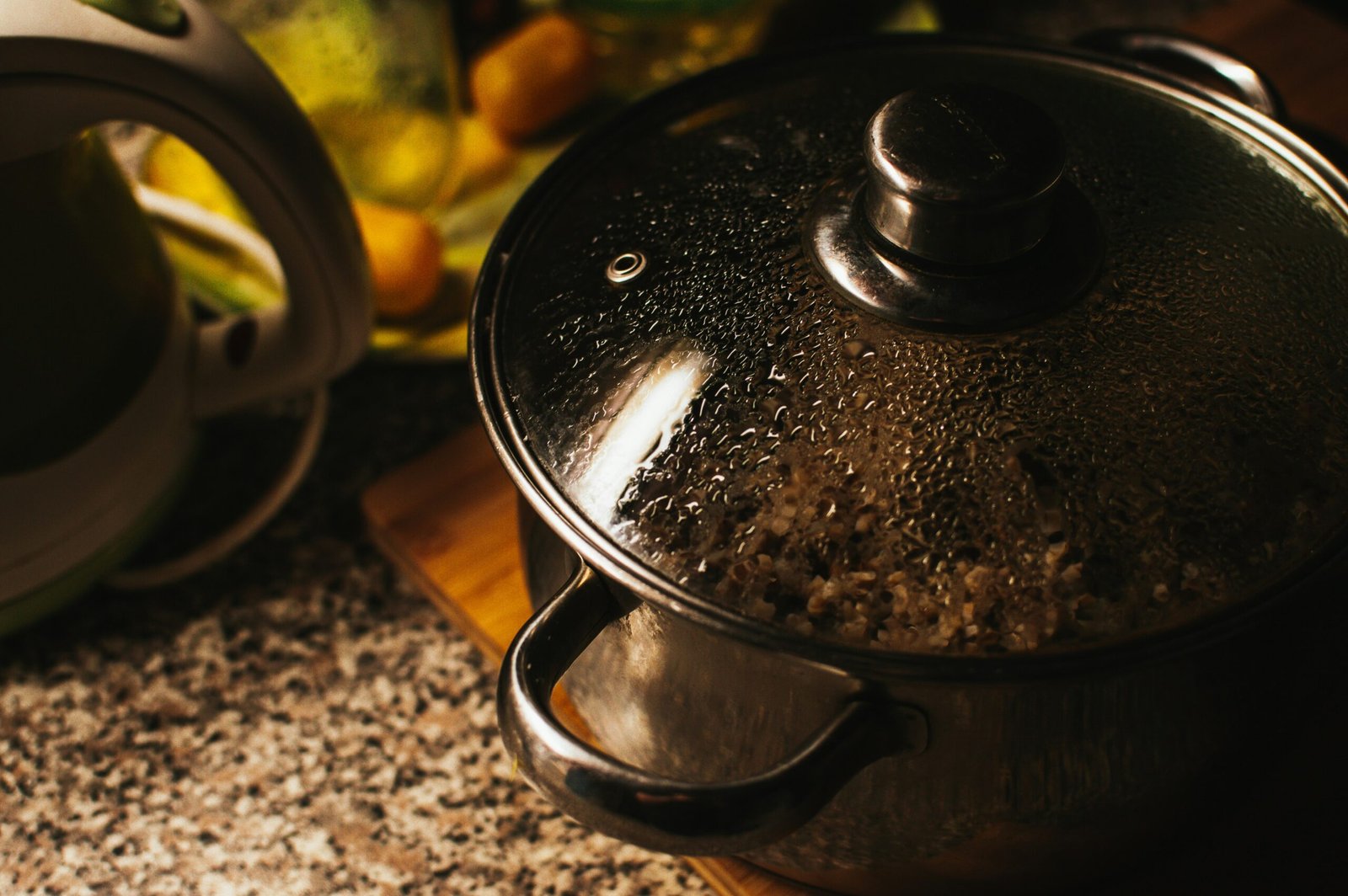 stainless steel cooking pot on brown wooden chopping board